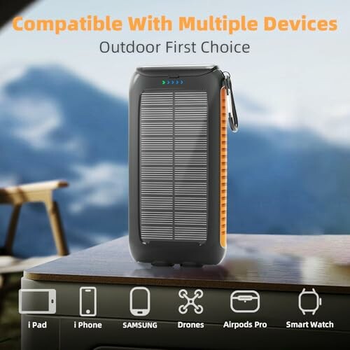Solar power bank on table with device compatibility icons.